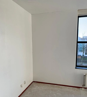 Van-gedateerde-woning-naar-instapklaar-appartement (2) Gerenoveerde witte muur na grondige schilderbeurt in slaapkamer